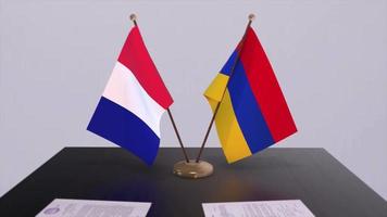 Armenia and France national flags on table in diplomatic conference room. Politics deal agreement video