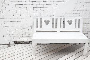 Lovely little heart engraved in long bench wooden chair colored in white ,interior design photo
