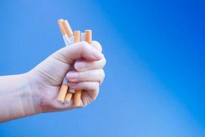 Broken cigarette on hand. Winning with addicted nicotine problems,No smoking. Quitting from addiction concept. photo