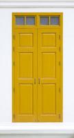 traditional yellow door wooden of an old on white wall,in Thailand photo