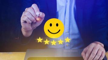 Customer services best excellent business rating experience, Positive Review and Feedback, Satisfaction survey concept. Hand of a businessman show happy smile face with five star. photo