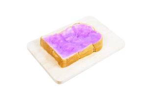 Purple sweet potato with jam butter toast on a wooden board isolated on white background.Toast bread photo