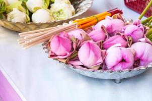 Pink Lotus flower, incense sticks and candles set for praying  buddha at temple photo