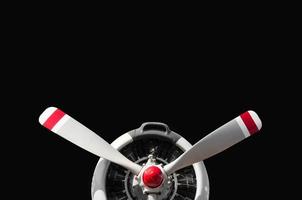 Vintage airplane propeller with radial engine on black background photo