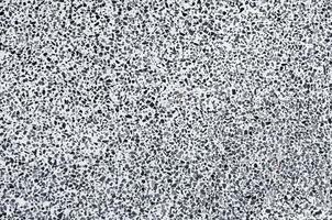 Texture stone paving of black pebble wall for pattern and abstract dark background photo