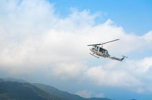 Helicopter in flight, blue sky background photo