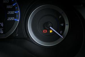 Detail with the fuel gauges showing and empty tank on dashboard of car photo