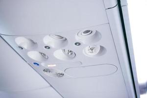 View of air conditioner console panel on board of an aircraft,airplane cabin with no smoking sign on photo