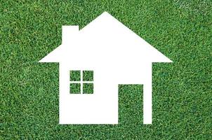 white house icon on grass texture background,Eco Architecture,Green Building,Image clean green house. Ecology photo