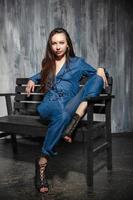 Chaming young woman dressed in denim overalls photo