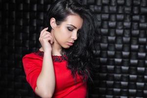 Pensive young woman in red dress photo