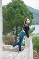 Young charming brunette on a background of mountains photo