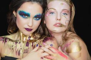 Two pretty young women with creative make-up photo