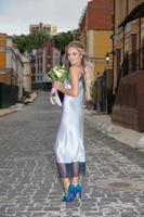 Cute woman with a wedding bouquet photo