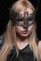 Portrait of a young beautiful blonde in a mask photo