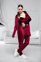 Charming brunette dressed in a burgundy velour suit photo