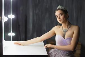 Lovely lady posing in a studio near the table photo