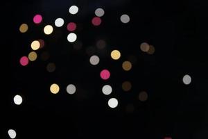On a black background bokeh from explosions of colorful fireworks. photo