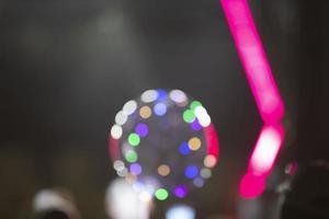 Bright pink stripes of optical bokeh on a dark background. photo