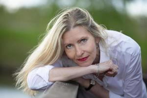 Portrait of a beautiful European-type middle-aged woman. Fifty-year-old blonde woman with a well-groomed face close-up. photo