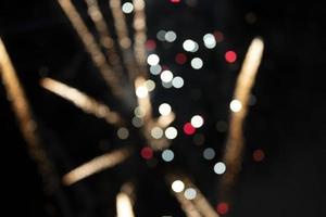 On a black background bokeh from explosions of colorful fireworks. photo