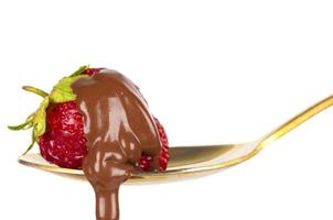 Strawberries on golden spoon with chocolate dipping isolated on white. Chocolate dripping from strawberries. Beautiful red berry. Sweet dessert. photo