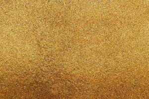 The texture of small gold chips or glitter. photo