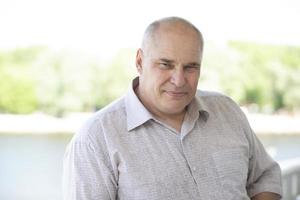 Portrait of an elderly man of European appearance. He looks into the camera. photo