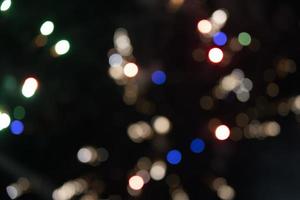 On a black background bokeh from explosions of colorful fireworks. photo