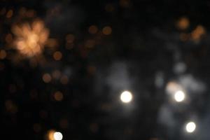 On a black background bokeh from explosions of colorful fireworks. photo