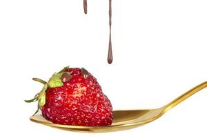 Strawberries on golden spoon with chocolate dipping isolated on white. Chocolate dripping from strawberries. Beautiful red berry. Sweet dessert. photo