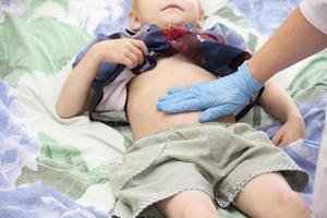 Child lying on examination couch at pediatrician's office photo