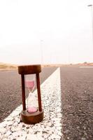 Hourglass on the road photo