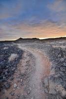 Path in the desert at sunset photo