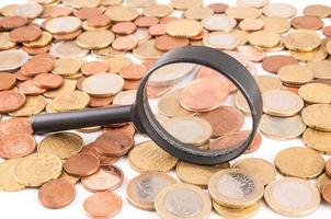 Magnifying glass and coins photo