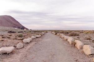 Dirt road in the desert photo