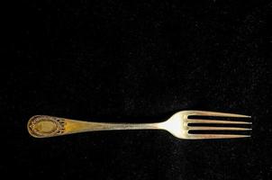 Fork on black background photo