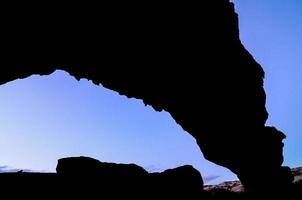 Natural rock arch silhouette photo