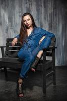 Nice young woman dressed in denim overalls photo