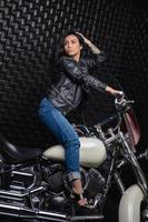 Alluring lady sitting on a motorcycle photo