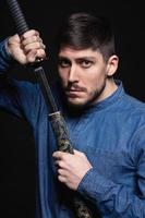 Pensive young man posing in studio photo