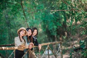 group  young women looking beautiful nature while camping in forest photo