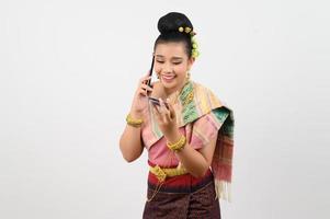 Young beautiful woman in northeastern dress use smartphone and credit card posture photo
