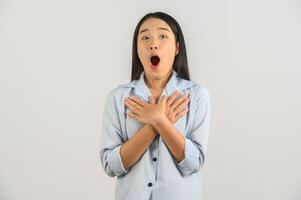 Portrait of Excited young asian woman in blue shirt isolated on white background photo