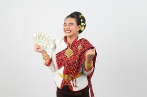 Portrait of Beautiful Thai Woman in Traditional Clothing Posing with fan Banknote photo