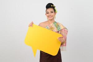 Young beautiful woman in Thai lanna costume with blank speech bubble sign photo