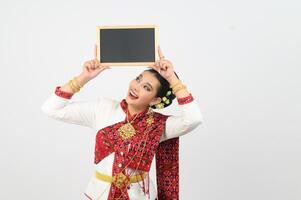 Portrait of Beautiful Thai Woman in Traditional Clothing Posing with blackboard photo