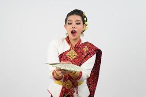 Portrait of Beautiful Thai Woman in Traditional Clothing Posing with fan Banknote photo