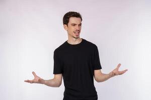 Portrait of puzzled clueless young man arms out asking why what's the problem who cares so what, I don't know photo