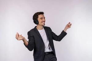 Portrait of happy young man wearing headphone and enjoy music over white background photo